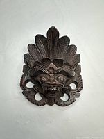 frontal view of carved Balinese wooden mask