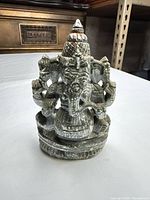 Front view of carved soapstone Ganesha statue on plinth