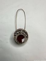 Full front view of brooch showing carnelian stone and filigree design