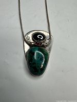 Front view of pendant showing stones and silver setting