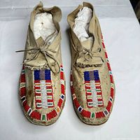 Top view of both moccasins showing beadwork and wear