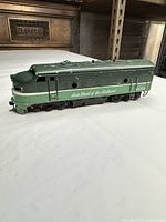 Left side view of dark green Tenshodo 6512A locomotive showing lettering and trucks