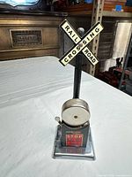 Front view showing crossbuck sign, bell, base label and terminals