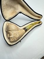 Pipe resting in open fitted case