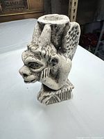 front angled view of concrete gargoyle statue