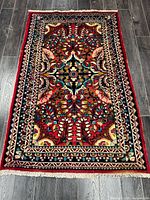 Full view of handmade Persian Tabriz wool rug on floor