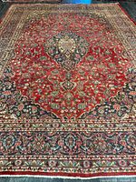 Full view showing entire rug pattern, colors and borders