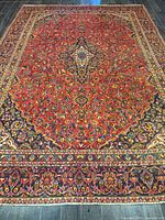 Full view of handmade Kashan rug showing field, medallion and border