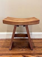 Full view of teak shower bench showing curved seat and legs