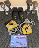 All dumbbells, resistance cords, cuffs and booklet grouped