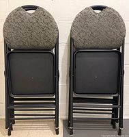 Six folding chairs stacked showing back and underside