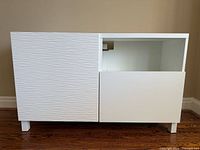 Front view showing textured door, open compartment, and drawer