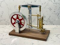 Front view of steam engine showing flywheel, cylinder and linkage