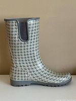 Side profile of left boot displaying houndstooth pattern and overall condition