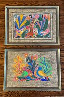 Both framed bark paintings side by side displaying size and colour