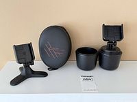 Lot overview showing CupFone mount with extra cup, desktop phone stand, PowerLocus headphone case