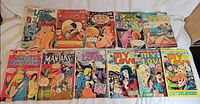 All eleven romance comic books laid out, showing front covers