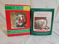 Front view of both ornament boxes showing graphics and branding