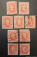 Front view of nine Australia 2½d red-orange King portrait stamps showing cancellations and condition
