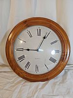 Front view of wall clock showing full face and frame