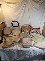 Group shot of all handbags, clutches and wallets displayed
