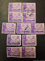 Group view of eleven 20 rupiah Indonesian purple Pelita stamps