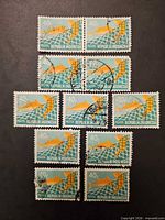 All 11 Indonesian 40 value Pelita fish stamps arranged on black background