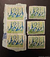 Full lot showing strip of three on paper and three loose stamps