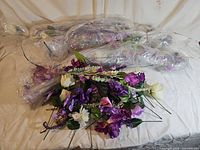 sealed bundles and opened bundle of artificial flower stems displayed