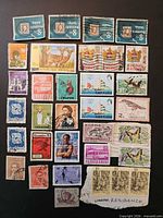 Full grid view of entire stamp lot on black background