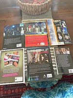 Rear covers of six One Direction paperbacks/magazines