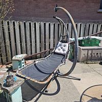 full view of metal cantilever garden swing lounger on patio