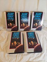 Front view of five Star Trek TNG VHS tapes in slipcases
