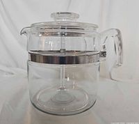 Side view of assembled glass percolator showing stainless band and handle