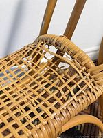 Close-up of rocking horse seat showing broken wicker strands