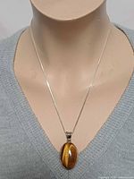 Full view of necklace on bust showing pendant and chain length