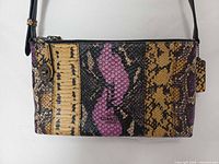 Front view showing multicolor python panels, turn-lock accent, logo