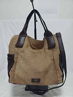 Front view of Fossil Emerson tan leather satchel showing handles, strap and brand plaque