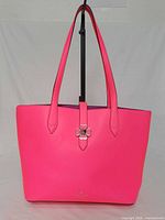 Front view of bright pink Kate Spade Kaci tote on stand