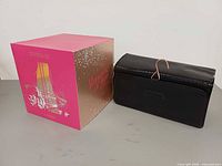 Lancome Holiday Glam Collection box beside black cosmetics bag