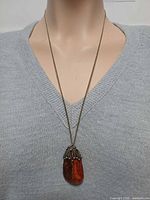 Necklace on mannequin showing pendant size and drop length