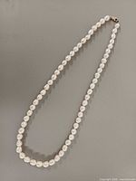 Full view of pearl necklace laid flat