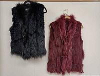 Front view of both fur vests hanging