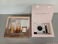 Front view of both boxed sets: Nuxe Charismatique gift set and Doll 10 makeup kit contents