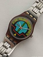 Front view showing dial design, case, bracelet, Swatch logo on clasp