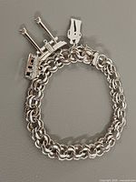 Full view of bracelet closed showing chain pattern and charms