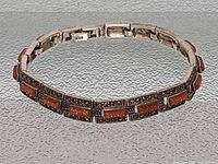 Bracelet closed showing link detail, goldstone inlays, marcasite borders, 925 mark visible