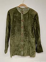 Full front view of green suede studded jacket on hanger