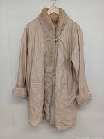 Full front view of beige leather coat with fur trim.