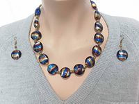 Necklace and earrings modelled on bust to show appearance